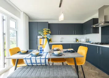 A Modern Kitchen With Dark Cabinets, A Dining Table With Yellow Chairs