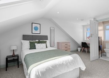 A Bright, Modern Master Bedroom Featuring A Comfor...