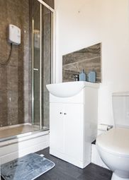 A Modern Bathroom Featuring A Shower Enclosure, A ...