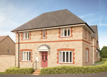 A Light-Colored Brick House With A Red Door And White-Trimmed Windows Sits Behind A Neatly Trimmed G