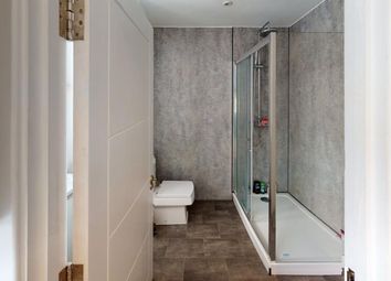 A Modern And Stylish Bathroom Featuring A Spacious...