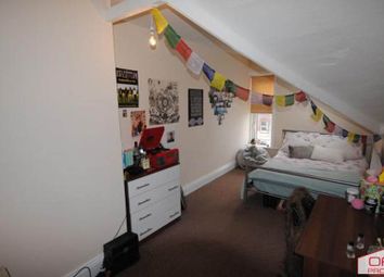 A Cozy Bedroom With A Single Bed, Decorated With P...