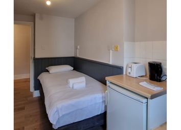 A Tidy And Inviting Single Bedroom With Essential ...