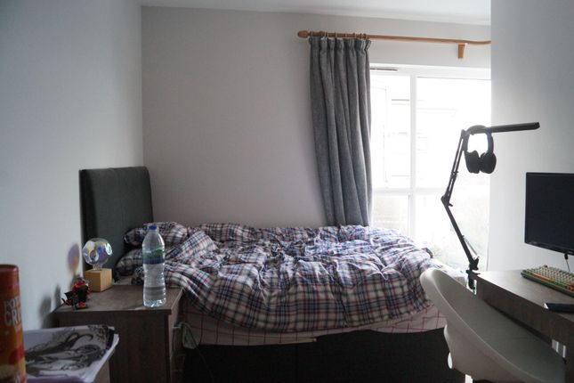 A Cozy Single Bedroom Featuring A Comfortable Bed ...