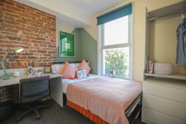 A Spacious And Stylish Bedroom Featuring An Expose...