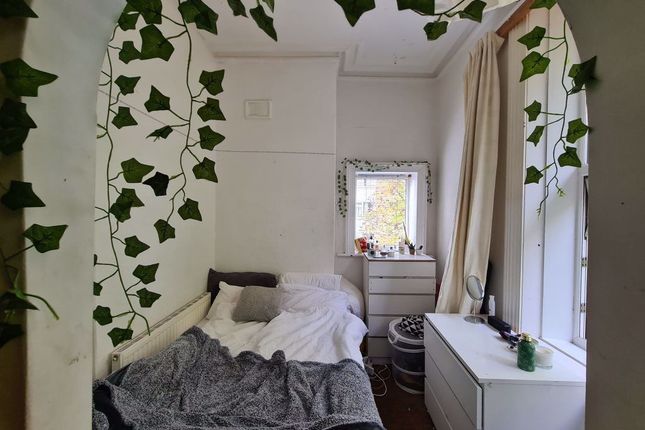 A Cozy Single Bedroom Featuring A Neatly Made Bed ...