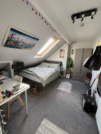 A Cozy Bedroom Featuring A Double Bed And A Stylis...