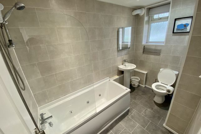 A Spacious And Modern Bathroom Featuring A Relaxin...