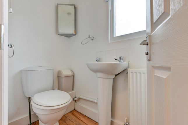 A Clean And Bright Bathroom Featuring A Toilet, A ...