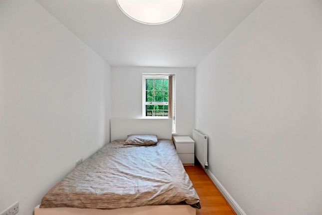 A Neat And Simple Bedroom Featuring A Single Bed W...