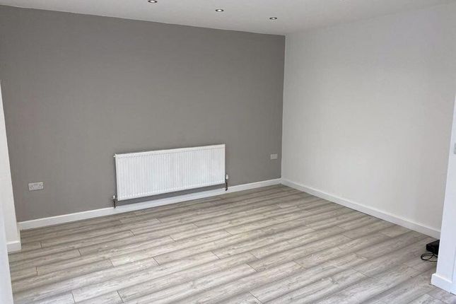 A Clean And Modern Living Room Featuring Light Woo...
