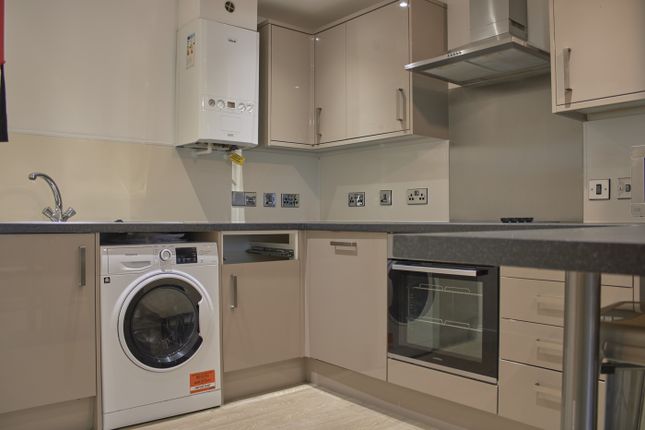 A Modern And Tidy Kitchen Featuring Essential Appl...