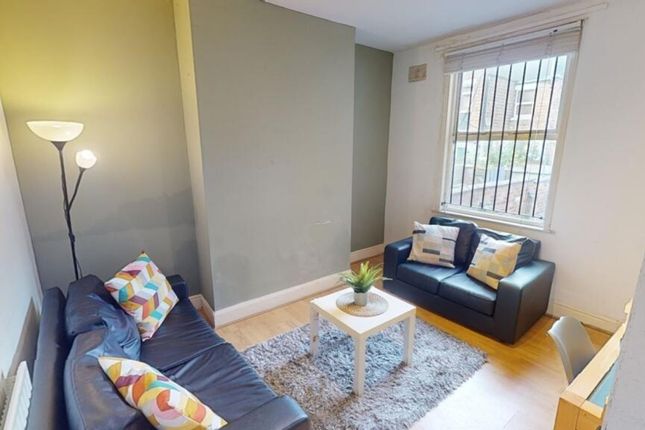 A Cozy Living Room Featuring Comfortable Seating A...