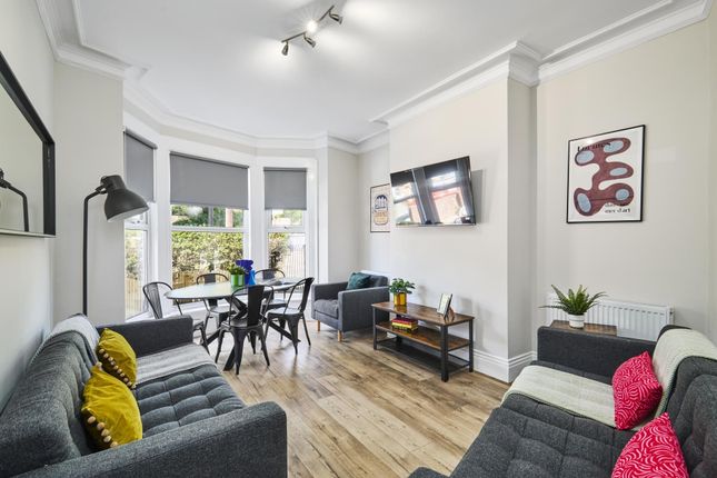 Bright And Modern Living Room Featuring Large Wind...