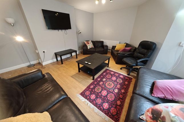 A Cozy And Inviting Living Room Featuring Comforta...