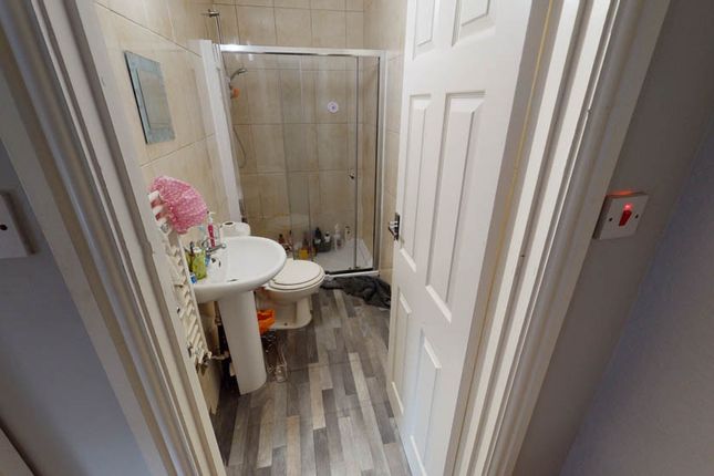 A Clean And Modern Bathroom With A Shower And Brig...