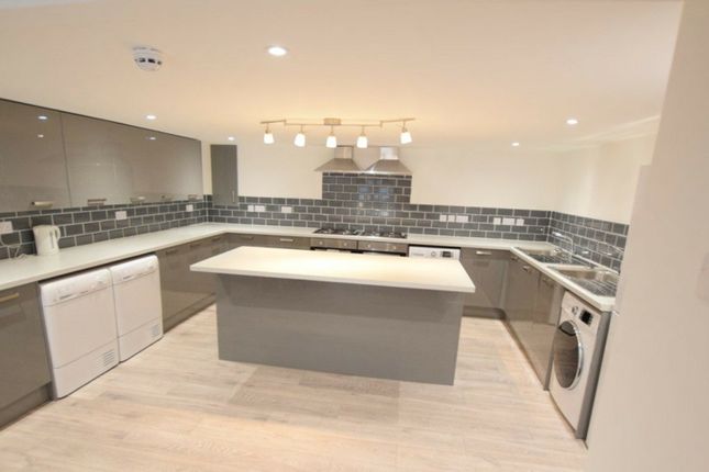 A Spacious And Modern Kitchen Featuring Sleek Cabi...