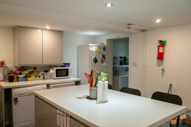 A Bright And Modern Kitchen Featuring A Spacious i...