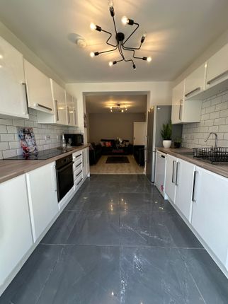 A Modern Kitchen Featuring Sleek Cabinetry And Sty...