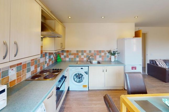 A Modern Kitchen Featuring Clean Countertops, Inte...