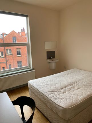 A Neat And Bright Single Bedroom Featuring A Large...
