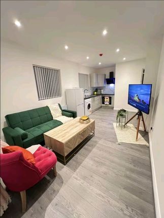 A Contemporary Living Room Featuring A Stylish Gre...