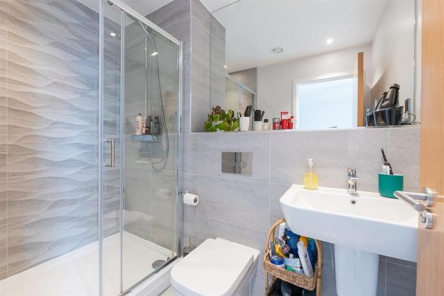 Modern And Sleek Bathroom Featuring A Large Walk-i...