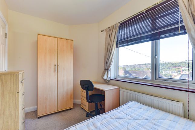 A Bright And Tidy Bedroom Featuring A Large Window...