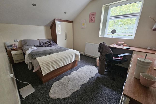 A Cozy Double Bedroom Featuring A Comfortable Bed,...