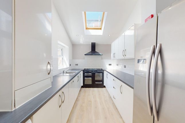 A Bright And Modern Kitchen Featuring Sleek Cabine...