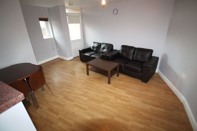 A Contemporary Living Room Featuring Wood Flooring...