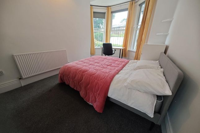A Bright Double Bedroom Featuring A Large Window W...