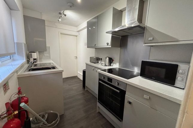 Modern Kitchen Equipped With Sleek Cabinets And Co...