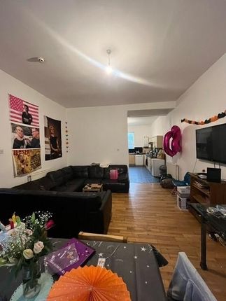 A Spacious And Well-Lit Living Room Featuring A Mo...