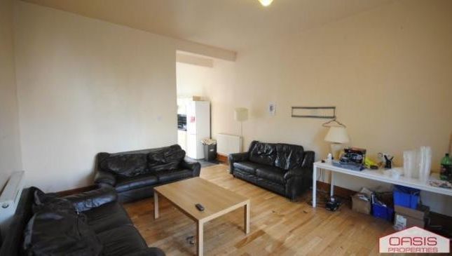 A Spacious And Well-Lit Living Room Featuring Mode...