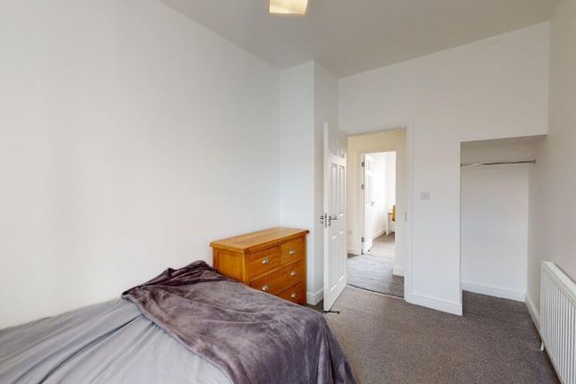 A Neat And Tidy Single Bedroom Featuring A Bed Wit...