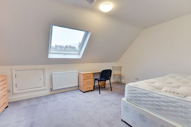 A Bright And Tidy Bedroom With A Large Skylight Th...