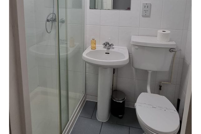 A Tidy And Functional Bathroom Featuring Modern fi...