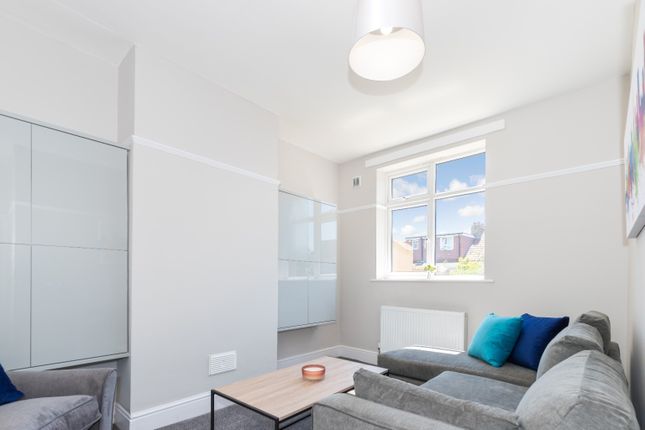 A Bright And Inviting Living Room Featuring Modern...