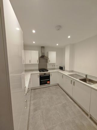 A Modern, Clean Kitchen Featuring Sleek White Cabi...