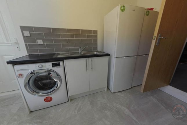 A Modern Kitchen Area Featuring Essential Applianc...