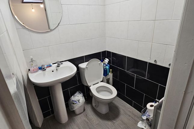 A Bright And Clean Bathroom Featuring A Sink, Toil...