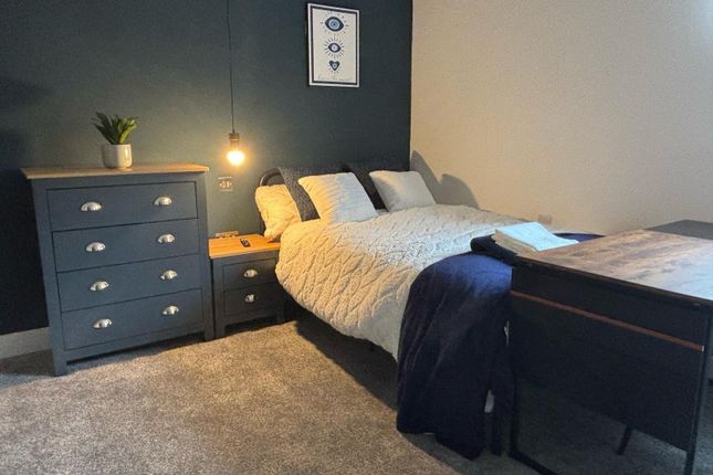 This Stylish Double Bedroom Features A Cozy Bed Wi...