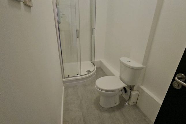 A Clean And Modern Bathroom Featuring A Compact Sh...