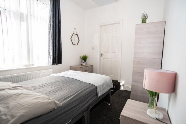 A Neatly Presented Bedroom With A Comfortable Sing...