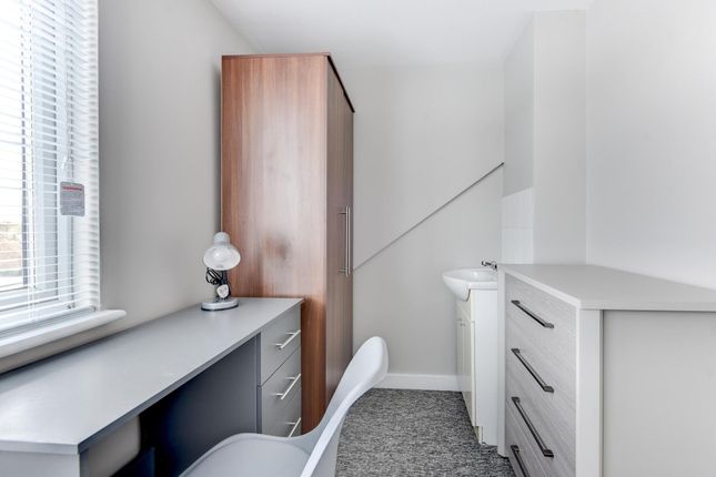 A Bright, Neatly Maintained Bedroom Featuring A De...