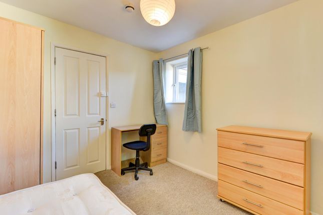 A Comfortable Double Bedroom Featuring A Window Wi...