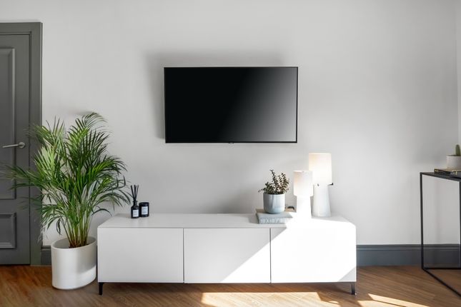 A Modern Living Room Featuring A Sleek Wall-Mounte...