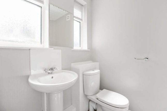 A Bright And Modern Bathroom Featuring A Sleek Sin...