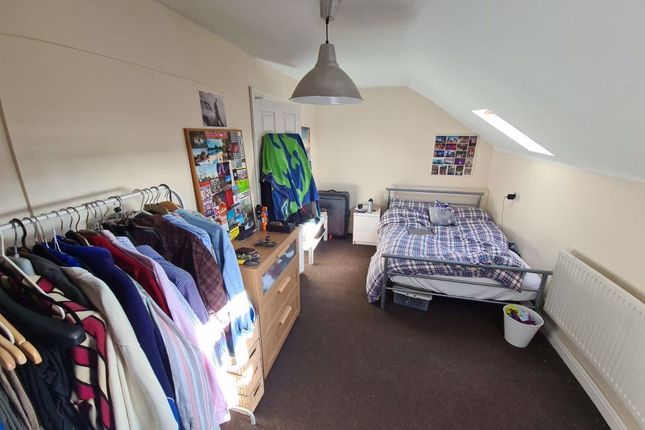 A Well-Lit Bedroom With A Neatly Made Bed, Ample S...